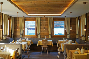 Interior design and decoration of European restaurant with view of snowy mountain range- Italy