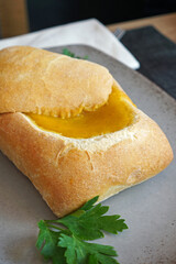 Close up pumpkin curry soup in bread bowl