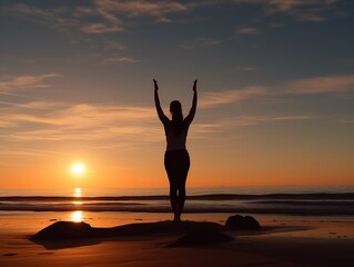 Silhouette of girl doing yoga at sunset on beach near the sea.