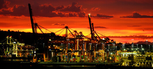 Lights and Sunrise or Sunset on Bay Dock Loading Cranes Business Loading and Unloading from Cargo Ships