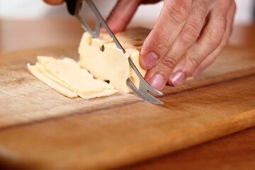 Chef slicing holey cheese