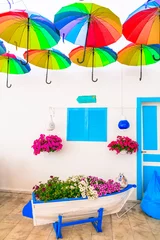 Gordijnen Beautiful street bar (restaurant) decoration with colorful umbrellas, old wooden boat and flowers. Bodrum,Turkey © Freesurf
