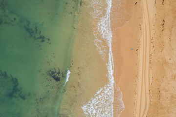 Fototapeta na wymiar Aerial drone view of sandy beach of Praia da Rocha and Atlantic Ocean waves, Algarve,Portugal