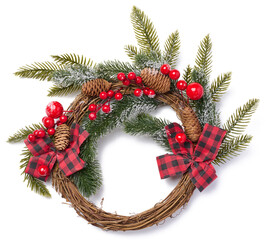 Fototapeta na wymiar Christmas wreath made of spruce branches, ribbon and red berries
