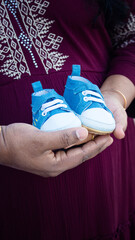 woman holding baby shoes, Frames from the baby shower Photo shoot 