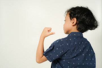 Healthy Asian boy with strong arm movements on white background isolated