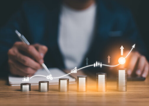 Financial business growth concept. Businessperson calculate income and profit on investments and an increase in the indicators of positive growth, interest rate and dividend concept with chart graph.