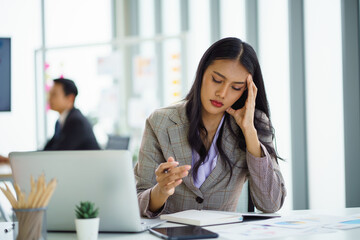 Asian businesswoman feeling stressful and headache after working for a long time, Office syndrome concept.