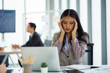 Fototapeta premium Asian businesswoman feeling stressful and headache after working for a long time, Office syndrome concept.