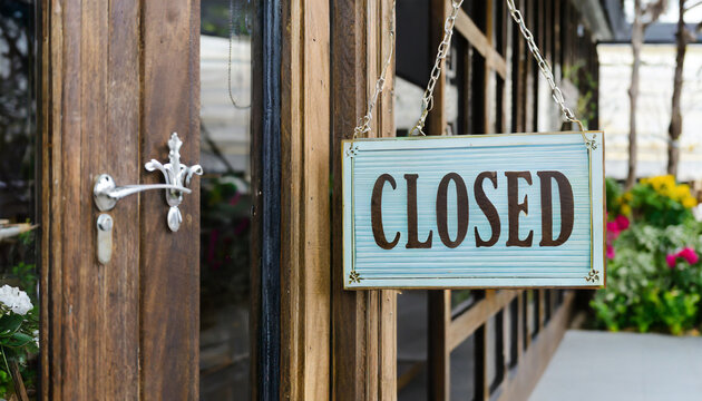 closed sign hanging outside a restaurant store office or other