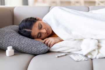Sick Young Indian Woman Sleeping With High Fever On Couch At Home