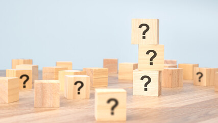 wooden cubes with question mark mean what on table background