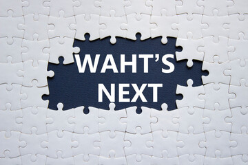 What is next symbol. Concept words What is next on white puzzle. Beautiful dark blue background. Business and What is next concept. Copy space.