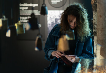 adult visitor woman in art history museum exhibition taking photo with smartphone mobile camera or scanning qr code of exhibit artwork - obrazy, fototapety, plakaty