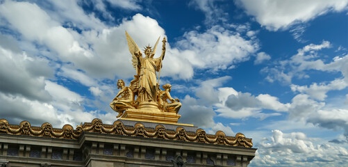 Golden statue of Liberty on the roof of the Opera Garnier (Garnier Palace)  against the sky with...
