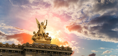 Golden statue of Liberty on the roof of the Opera Garnier (Garnier Palace)  against the sky at...