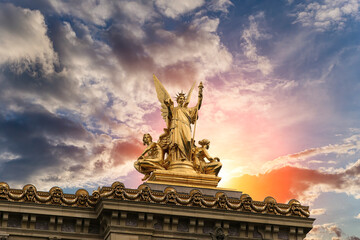Golden statue of Liberty on the roof of the Opera Garnier (Garnier Palace)  against the sky at...
