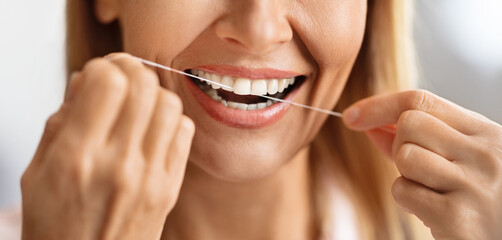 Oral Care. Closeup Shot Of Smiling Mature Female Using Dental Floss - obrazy, fototapety, plakaty