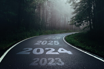 2024 New Year road trip travel and future vision concept . Nature landscape with highway road leading forward to happy new year celebration in the beginning of 2024 for fresh and successful start . - obrazy, fototapety, plakaty