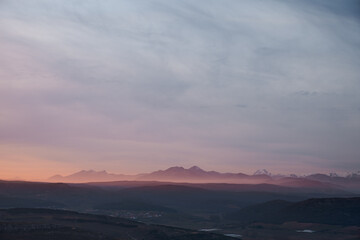 A pink iluminated mist covers the valley in a winter sunset in Spain © EvaMara