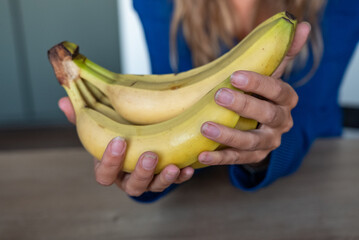 The woman holds food in her hand. the girl holds in her hands