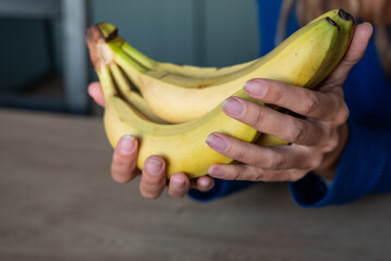 The woman holds food in her hand. the girl holds in her hands