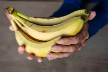 The woman holds food in her hand. the girl holds in her hands