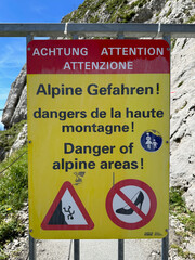Caution Sign for Alpine Hikers in German, French, and English on Mount Pilatus
