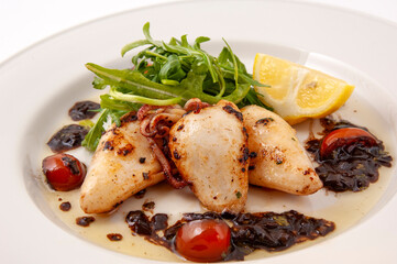 grilled whole squid with salad and tomatos
