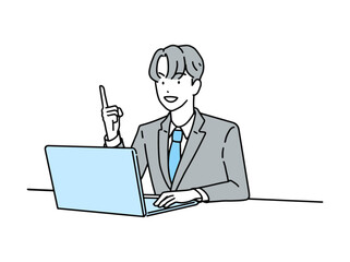 PCを操作しながら指差しポーズをする男性ビジネスパーソン
