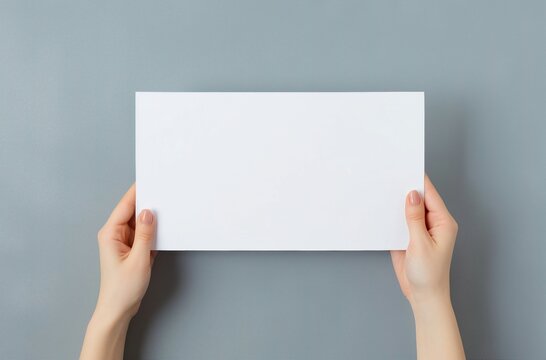 A Person Holding Up A Blank White Sign