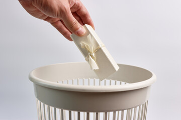 Old gift wrapping is thrown into the trash for recycling or disposal.