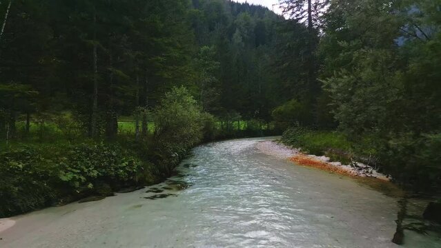 Aerial drone fly above The Krumme Steyr river near the village Hinterstoder and famous lake Schiederweiher. Pure fresh water near Austrian Alps and mountains peaks. Soft colors, peace in nature.