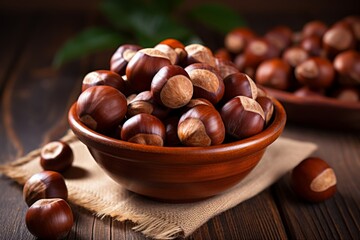 Obraz premium A Warm and Inviting Bowl of Roasted Chestnuts, Perfectly Browned and Cracked Open, Sitting on a Rustic Wooden Table Amidst Christmas Decorations