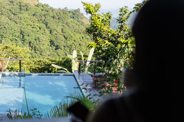 View of mountains with a woman drinking coffee