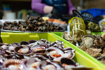 A traditional seafood market with a close-up of the scallops