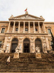 Madrid. Spain - 23 November 2022: Unrecognizable Person on the stairs. Principal facade of The National Library of Spain