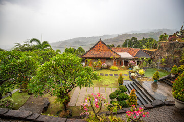 A Buddhist temple in the evening in the rain. The Brahmavihara-Arama temple has beautiful gardens and also houses a monastery. Tropical plants near Banjar, Bali