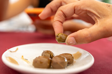 Indulging in a savory moment, capturing the essence of the Mediterranean with a single olive.