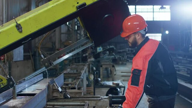 Manufacture industrial production zone factory worker with safety equipment working at the heavy machinery