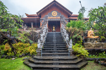 A Buddhist temple in the evening in the rain. The Brahmavihara-Arama temple has beautiful gardens...