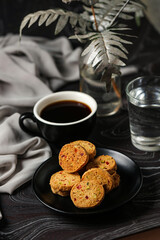Crunchy cookies biscuits served in plate with black coffee and glass of water isolated on table side view of american cafe baked food