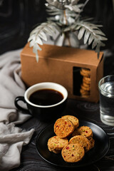 Crunchy cookies biscuits served in plate with cookie box, black coffee and glass of water isolated on table side view of american cafe baked food