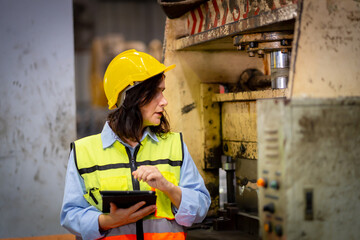 Young female engineer in metal sheet factory Responsible work is being inspected at the actual work...