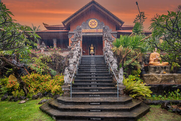 A Buddhist temple in the evening in the rain. The Brahmavihara-Arama temple has beautiful gardens and also houses a monastery. Tropical plants near Banjar, Bali