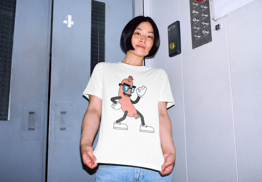 Mockup of woman wearing customizable t-shirt in elevator, low angle