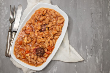 typical portuguese dish dobrada with beans in white dish