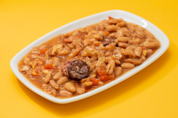typical portuguese dish dobrada with beans in white dish