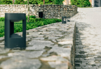 Decorative floor lamps on a stone wall. Selective focus.
