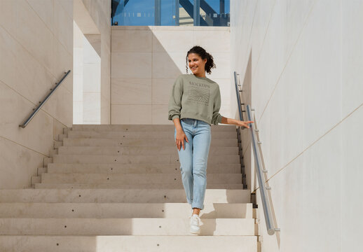 Mockup of woman wearing customizable sweatshirt on steps